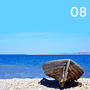 Motiv: Ruderboot am Steinstrand